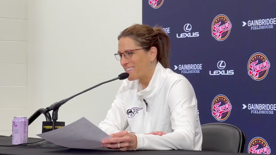 Fever coach White smiles as she talks to reporters postgame | Screengrab via @ScottAgness on X/Twitter