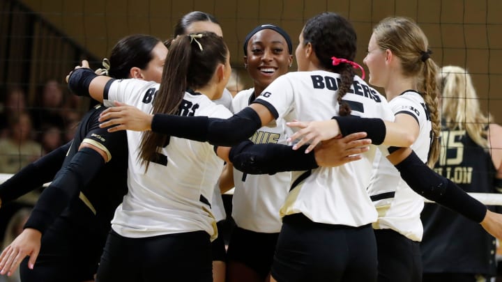 Purdue Boilermakers huddle after scoring during a volleyball match 