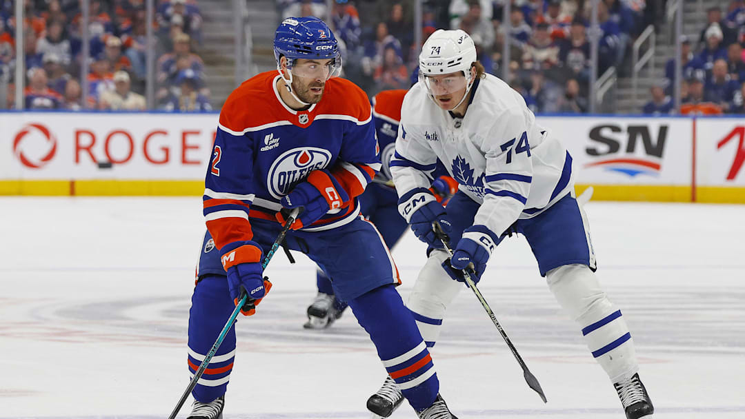 Feb 3, 2026; Edmonton, Alberta, CAN; Edmonton Oilers defensemen Evan Bouchard (2) looks to make a pass in front of Toronto Maple Leafs forward Bobby McMann (74) during the first period at Rogers Place. Mandatory Credit: Perry Nelson-Imagn Images