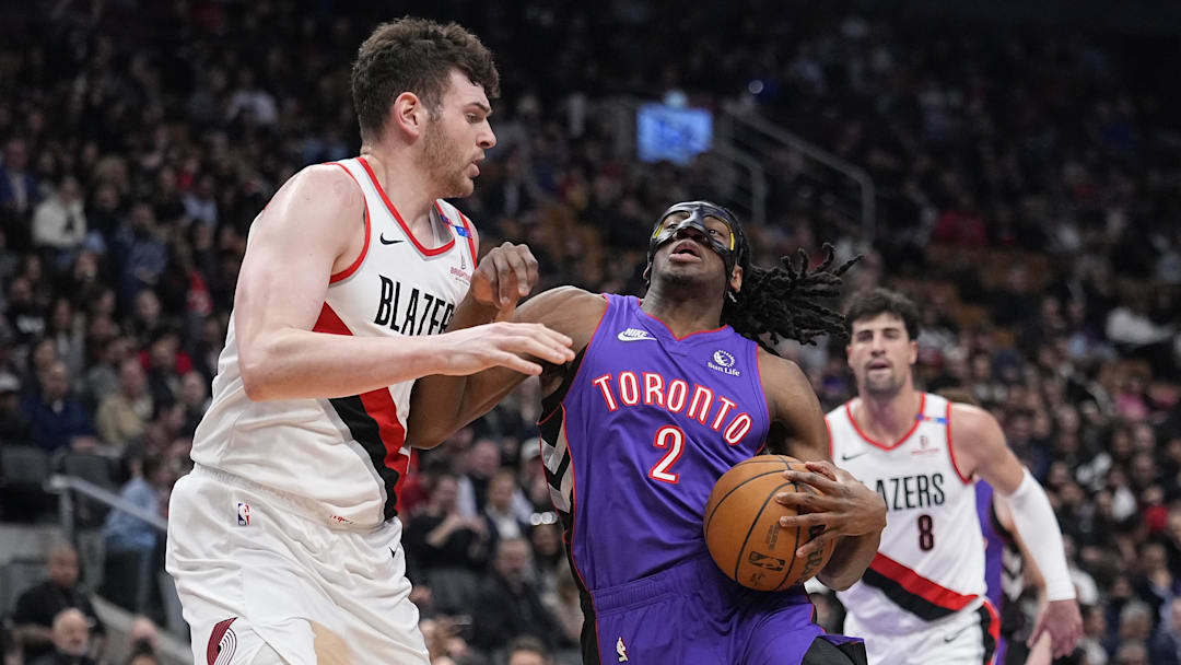 Apr 3, 2025; Toronto, Ontario, CAN; Toronto Raptors forward Jonathan Mogbo (2) drives to the net againat Portland Trail Blazers center Donovan Clingan (23) during the first half at Scotiabank Arena. Mandatory Credit: John E. Sokolowski-Imagn Images