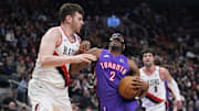 Apr 3, 2025; Toronto, Ontario, CAN; Toronto Raptors forward Jonathan Mogbo (2) drives to the net againat Portland Trail Blazers center Donovan Clingan (23) during the first half at Scotiabank Arena. Mandatory Credit: John E. Sokolowski-Imagn Images