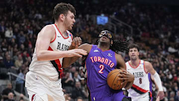 Apr 3, 2025; Toronto, Ontario, CAN; Toronto Raptors forward Jonathan Mogbo (2) drives to the net againat Portland Trail Blazers center Donovan Clingan (23) during the first half at Scotiabank Arena. Mandatory Credit: John E. Sokolowski-Imagn Images