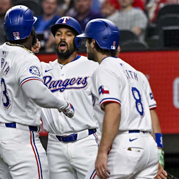 Sep 5, 2024; Arlington, Texas, USA; Texas Rangers right fielder Adolis Garcia (53) and second baseman Marcus Semien (2) and shortstop Josh Smith (8) celebrates after Garcia hits a three run home run against the Los Angeles Angels during the first inning at Globe Life Field. Mandatory Credit: Jerome Miron-Imagn Images