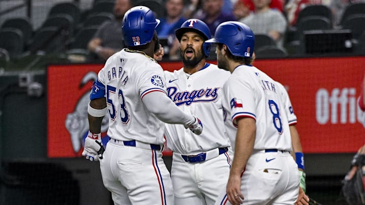 Sep 5, 2024; Arlington, Texas, USA; Texas Rangers right fielder Adolis Garcia (53) and second baseman Marcus Semien (2) and shortstop Josh Smith (8) celebrates after Garcia hits a three run home run against the Los Angeles Angels during the first inning at Globe Life Field. Mandatory Credit: Jerome Miron-Imagn Images