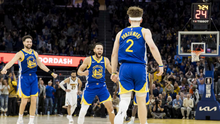 Jan 4, 2024; San Francisco, California, USA; Golden State Warriors guard Brandin Podziemski (2) celebrates with Klay Thompson (11) and Stephen Curry (30) after he scored against the Denver Nuggets during the second half at Chase Center. 