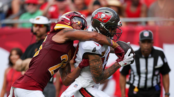 Sep 8, 2024; Tampa, Florida, USA; Tampa Bay Buccaneers wide receiver Mike Evans (13) catches a passs for a touchdown defended by Washington Commanders cornerback Benjamin St-Juste (25) in the second quarter at Raymond James Stadium. Mandatory Credit: Nathan Ray Seebeck-Imagn Images