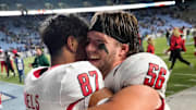 Nov 30, 2024; Chapel Hill, North Carolina, USA; North Carolina State Wolfpack tight end Dante Daniels (87) and offensive lineman Zeke Correll (56) celebrate after the game at Kenan Memorial Stadium. Mandatory Credit: Bob Donnan-Imagn Images