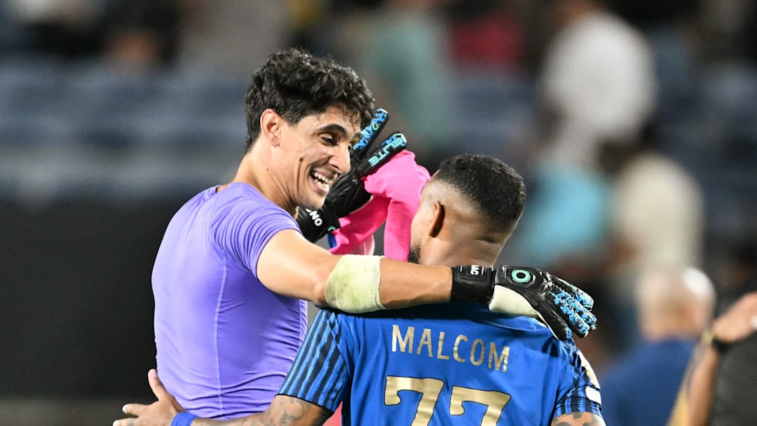 Yassine Bounou and Malcolm congratulate each other after Al-Hilal's historic win over Manchester City.
