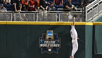 Jun 15, 2024; Omaha, NE, USA;  Texas A&M Aggies right fielder Jace Laviolette (17) makes a catch against the wall against the Florida Gators during the ninth inning at Charles Schwab Field Omaha. Mandatory Credit: Steven Branscombe-USA TODAY Sports