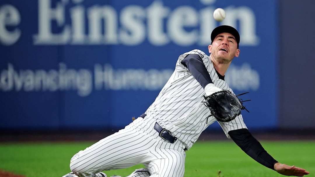 Oct 8, 2025; Bronx, New York, USA; New York Yankees left fielder Cody Bellinger (35) slides to makes a catch during the first inning against the Toronto Blue Jays during game four of the ALDS round for the 2025 MLB playoffs at Yankee Stadium. Mandatory Credit: Brad Penner-Imagn Images