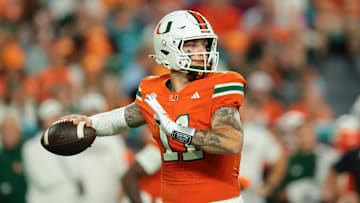 Oct 17, 2025; Miami Gardens, Florida, USA; Miami Hurricanes quarterback Carson Beck (11) throws the football against the Louisville Cardinals during the first quarter at Hard Rock Stadium. Mandatory Credit: Sam Navarro-Imagn Images