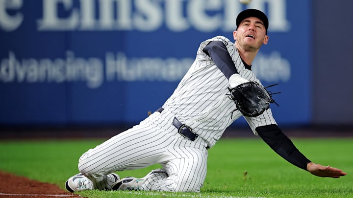 Oct 8, 2025; Bronx, New York, USA; New York Yankees left fielder Cody Bellinger (35) slides to makes a catch during the first inning against the Toronto Blue Jays during game four of the ALDS round for the 2025 MLB playoffs at Yankee Stadium. Mandatory Credit: Brad Penner-Imagn Images