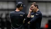 May 10, 2025; New Orleans, LA, USA;  New Orleans Saints head coach Kellen Moore talks with defensive coordinator Brandon Staley during rookie minicamp at Ochsner Sports Performance Center. Mandatory Credit: Stephen Lew-Imagn Images