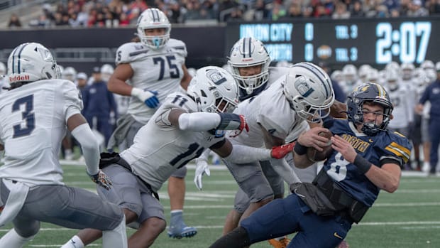 North’s TJ Valerio pushes hard but can’t quite make it into the end zone in early action. 