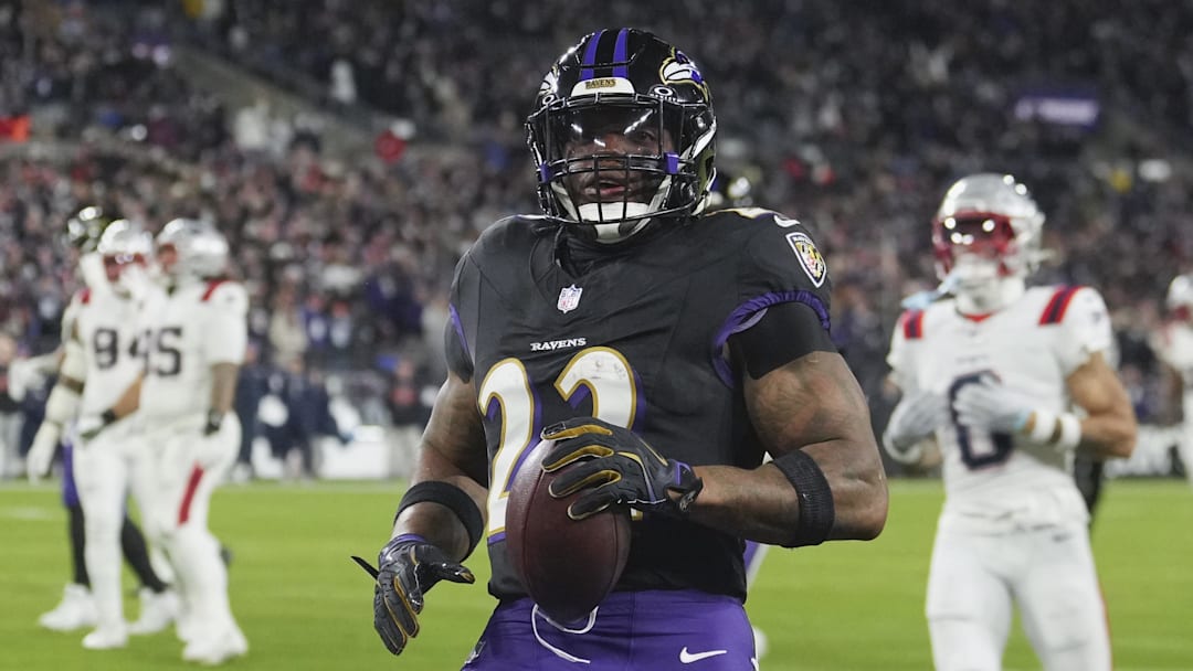 Dec 21, 2025; Baltimore, Maryland, USA;  Baltimore Ravens running back Derrick Henry (22) runs for a touchdown against the New England Patriots during the first quarter at M&T Bank Stadium. Mandatory Credit: Mitch Stringer-Imagn Images