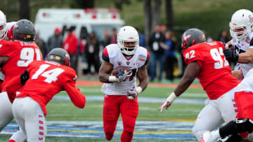 Dec 19, 2015; Albuquerque, NM, USA; Arizona Wildcats running back Orlando Bradford (21) runs the ball as New Mexico Lobos safety Daniel Henry (14) and defensive lineman William Udeh (92) defend during the second half in the 2015 New Mexico Bowl at University Stadium. Mandatory Credit: Matt Kartozian-USA TODAY Sports