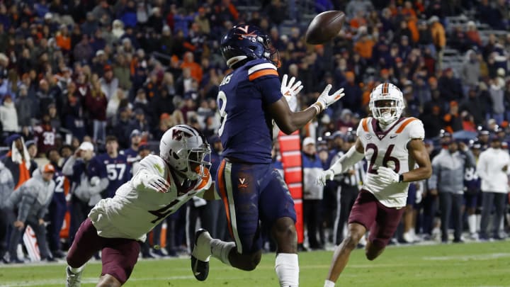 Nov 25, 2023; Charlottesville, Virginia, USA; Virginia Cavaliers wide receiver Malachi Fields (8) catches a touchdown pass as Virginia Tech Hokies cornerback Mansoor Delane (4) defends during the third quarter at Scott Stadium. Mandatory Credit: Geoff Burke-USA TODAY Sports