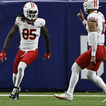 Jun 8, 2025; St. Louis, MO, USA; DC Defenders wide receiver Seth Williams (85) reacts with quarterback Jordan Ta'amu (10) after scoring a touchdown against the St. Louis Battlehawks at The Dome at America’s Center. Mandatory Credit: Jeff Le-Imagn Images