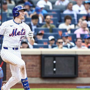 May 29, 2024; New York City, New York, USA;  New York Mets third base Brett Baty (22) hits a single in the third inning against the Los Angeles Dodgers at Citi Field. Mandatory Credit: Wendell Cruz-Imagn Images