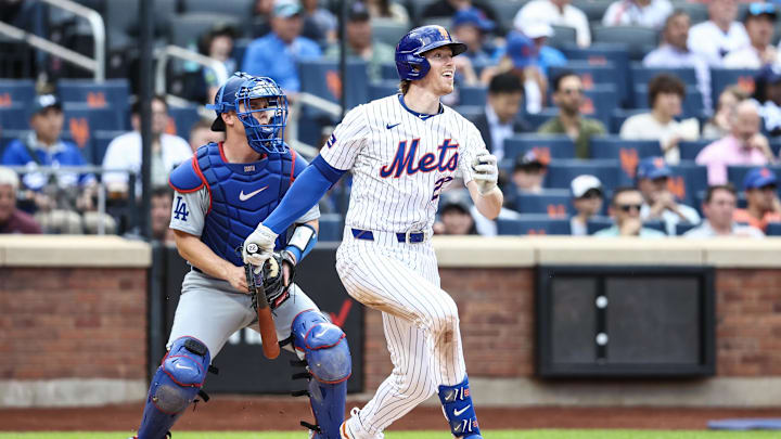 May 29, 2024; New York City, New York, USA;  New York Mets third base Brett Baty (22) hits a single in the third inning against the Los Angeles Dodgers at Citi Field. Mandatory Credit: Wendell Cruz-Imagn Images