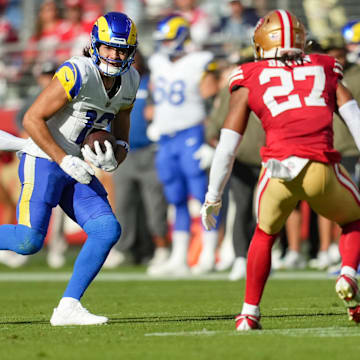 Nov 9, 2025; Santa Clara, California, USA; Los Angeles Rams wide receiver Puka Nacua (12) runs with the ball past San Francisco 49ers cornerback Upton Stout (20) during the second quarter at Levi's Stadium. Mandatory Credit: Cary Edmondson-Imagn Images