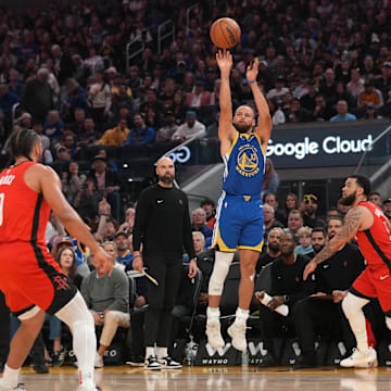 Golden State Warriors guard Stephen Curry shoots over Houston Rockets guard Fred VanVleet.