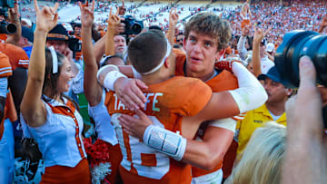 Texas Longhorns quarterback Arch Manning hugs Texas Longhorns defensive back Michael Taaffe after the game against the Oklahoma Sooners