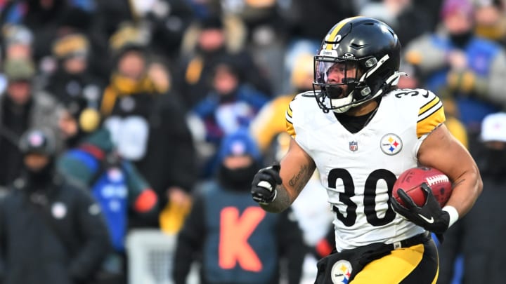 Jan 15, 2024; Orchard Park, New York, USA; Pittsburgh Steelers running back Jaylen Warren (30) runs the ball in the first half against the Buffalo Bills in a 2024 AFC wild card game at Highmark Stadium. Mandatory Credit: Mark Konezny-USA TODAY Sports