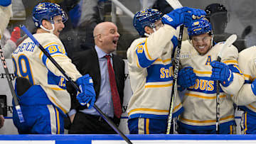 Feb 8, 2025; St. Louis, Missouri, USA;  St. Louis Blues left wing Pavel Buchnevich (89) head coach Jim Montgomery center Dylan Holloway (81) and center Robert Thomas (18) react after center Radek Faksa (not pictured) scored the game winning goal in the 10th round of shootouts against the Chicago Blackhawks at Enterprise Center. Mandatory Credit: Jeff Curry-Imagn Images
