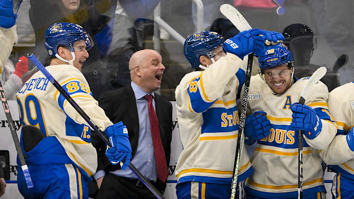 Feb 8, 2025; St. Louis, Missouri, USA;  St. Louis Blues left wing Pavel Buchnevich (89) head coach Jim Montgomery center Dylan Holloway (81) and center Robert Thomas (18) react after center Radek Faksa (not pictured) scored the game winning goal in the 10th round of shootouts against the Chicago Blackhawks at Enterprise Center. Mandatory Credit: Jeff Curry-Imagn Images