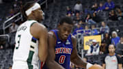 Dec 6, 2025; Detroit, Michigan, USA;  Detroit Pistons center Jalen Duren (0) dribbles defended by Milwaukee Bucks center Myles Turner (3) in the second half at Little Caesars Arena. Mandatory Credit: Rick Osentoski-Imagn Images