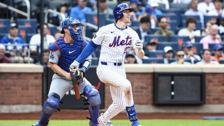 May 29, 2024; New York City, New York, USA;  New York Mets third base Brett Baty (22) hits a single in the third inning against the Los Angeles Dodgers at Citi Field. Mandatory Credit: Wendell Cruz-USA TODAY Sports