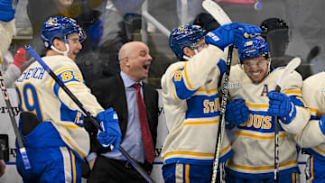 Feb 8, 2025; St. Louis, Missouri, USA;  St. Louis Blues left wing Pavel Buchnevich (89) head coach Jim Montgomery center Dylan Holloway (81) and center Robert Thomas (18) react after center Radek Faksa (not pictured) scored the game winning goal in the 10th round of shootouts against the Chicago Blackhawks at Enterprise Center. Mandatory Credit: Jeff Curry-Imagn Images