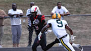 Mt. Healthy wide receiver Jai'mier Scott (0) catches a pass in front of Taft defender Adam Kirtley (9) during the Owls' 20-16 win Friday, Sept. 13, 2024.