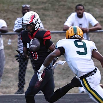Mt. Healthy wide receiver Jai'mier Scott (0) catches a pass in front of Taft defender Adam Kirtley (9) during the Owls' 20-16 win Friday, Sept. 13, 2024.