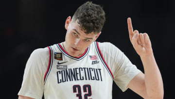 Apr 6, 2024; Glendale, AZ, USA; Connecticut Huskies center Donovan Clingan (32) reacts against the Alabama Crimson Tide in the semifinals of the men's Final Four of the 2024 NCAA Tournament at State Farm Stadium. Mandatory Credit: Robert Deutsch-USA TODAY Sports