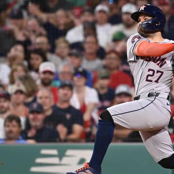 Aug 9, 2024; Boston, Massachusetts, USA; Houston Astros second baseman Jose Altuve (27) hits a two-run home run during the seventh inning against the Boston Red Sox at Fenway Park. 