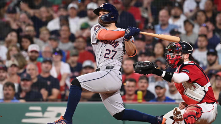 Aug 9, 2024; Boston, Massachusetts, USA; Houston Astros second baseman Jose Altuve (27) hits a two-run home run during the seventh inning against the Boston Red Sox at Fenway Park. 