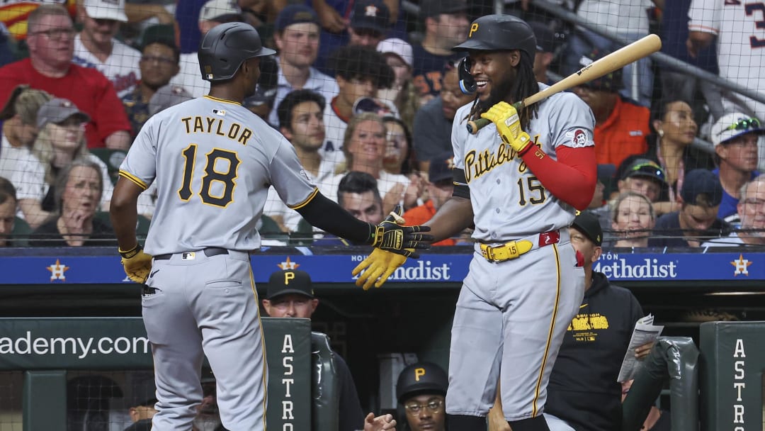 Jul 29, 2024; Houston, Texas, USA; Pittsburgh Pirates center fielder Michael A. Taylor (18) celebrates with shortstop Oneil Cruz (15) after hitting a home run during the ninth inning at Minute Maid Park. Mandatory Credit: Troy Taormina-USA TODAY Sports