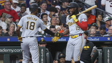 Jul 29, 2024; Houston, Texas, USA; Pittsburgh Pirates center fielder Michael A. Taylor (18) celebrates with shortstop Oneil Cruz (15) after hitting a home run during the ninth inning at Minute Maid Park. Mandatory Credit: Troy Taormina-USA TODAY Sports