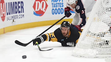 Mar 21, 2025; Pittsburgh, Pennsylvania, USA;  Pittsburgh Penguins right wing Kevin Hayes (13) pushes the puck away from Columbus Blue Jackets defenseman Jack Johnson (3) during the third period at PPG Paints Arena. Mandatory Credit: Charles LeClaire-Imagn Images