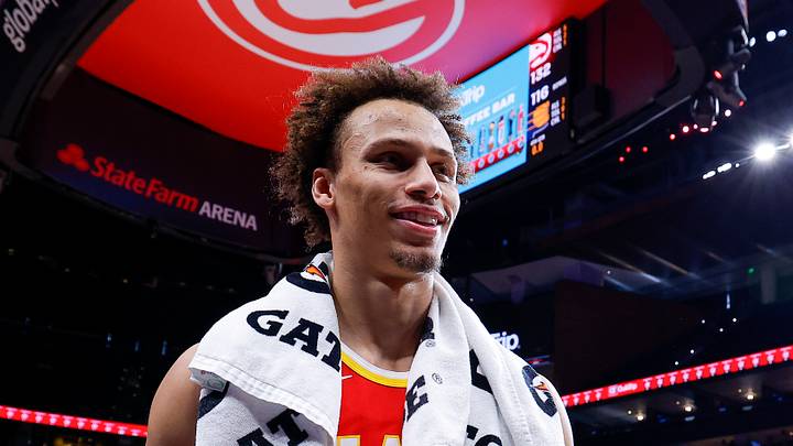 Dyson Daniels smiles as he walks off the court