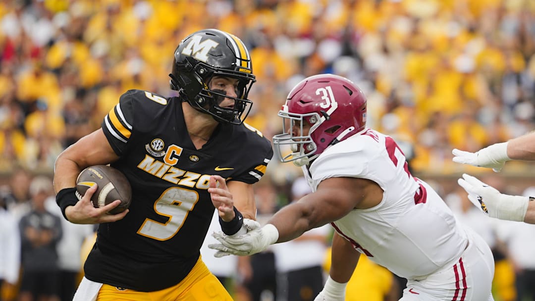Oct 11, 2025; Columbia, Missouri, USA; Missouri Tigers quarterback Beau Pribula (9) runs the ball against Alabama Crimson Tide defensive lineman Keon Keeley (31) during the second half of the game at Faurot Field at Memorial Stadium. Mandatory Credit: Jay Biggerstaff-Imagn Images