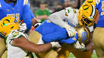 Sep 28, 2024; Pasadena, California, USA; Oregon Ducks defensive end Matayo Uiagalelei (10) and defensive lineman Derrick Harmon (55) sacks CLA Bruins quarterback Ethan Garbers (4) at Rose Bowl. Mandatory Credit: Robert Hanashiro-Imagn Images