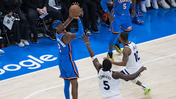 May 22, 2025; Oklahoma City, Oklahoma, USA; Oklahoma City Thunder guard Shai Gilgeous-Alexander (2) shoots against Minnesota Timberwolves guard Anthony Edwards (5) in the third quarter during Game 2 of the Western Conference Finals at Paycom Center. Mandatory Credit: Brett Rojo-Imagn Images