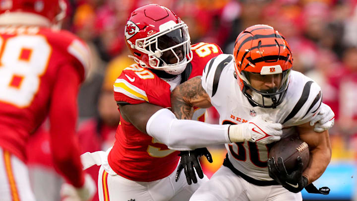 Kansas City Chiefs defensive end Charles Omenihu (90) tackles Cincinnati Bengals running back Chase Brown (30) for a loss in the first quarter during a Week 17 NFL football game between the Cincinnati Bengals and the Kansas City Chiefs, Sunday, Dec. 31, 2023, at GEHA Field at Arrowhead Stadium in Kansas City, Mo.