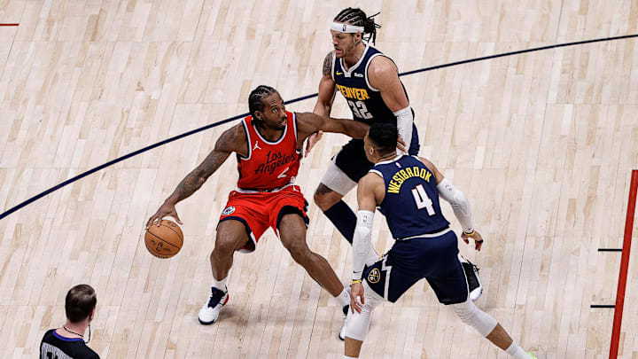 Apr 21, 2025; Denver, Colorado, USA; Los Angeles Clippers forward Kawhi Leonard (2) controls the ball as Denver Nuggets forward Aaron Gordon (32) and guard Russell Westbrook (4) guards in the fourth quarter during game two of first round for the 2025 NBA Playoffs at Ball Arena. Mandatory Credit: Isaiah J. Downing-Imagn Images
