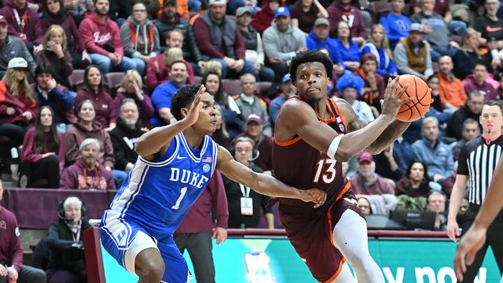 Jan 31, 2026; Blacksburg, Virginia, USA;  Virginia Tech Hokies forward Amani Hansberry (13) drives toward the basket defended by Duke Blue Devils guard Caleb Foster (1) at Cassell Coliseum. Mandatory Credit: Brian Bishop-Imagn Images