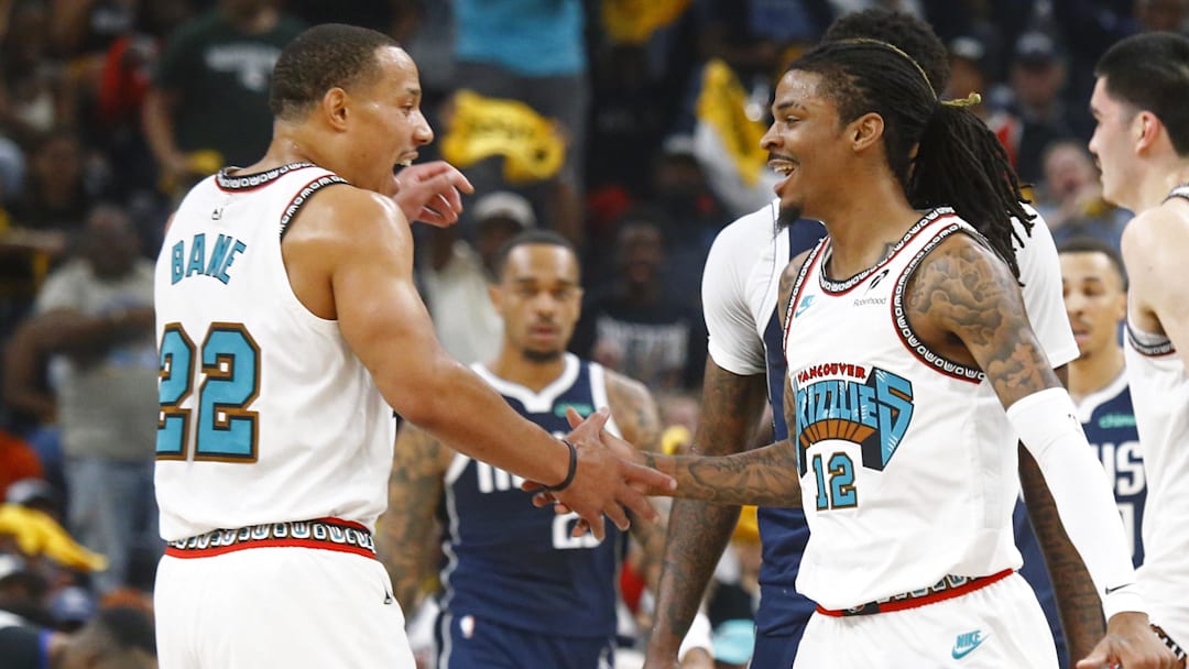 Apr 18, 2025; Memphis, Tennessee, USA; Memphis Grizzlies guard Ja Morant (12) reacts with guard Desmond Bane (22) during the first quarter against the Dallas Mavericks at FedExForum. Mandatory Credit: Petre Thomas-Imagn Images