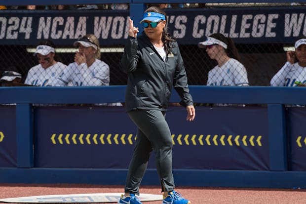 UCLA Bruins head coach Kelly Inouye-Perez signals to her players as they come off the field